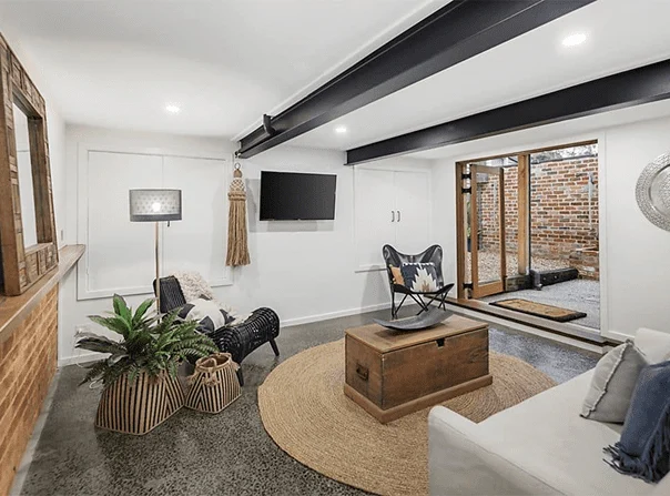 39 kangarooground Stylish basement renovation with polished concrete floors, exposed beams, and outdoor access by Coys Constructions.