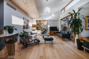 MARIAN HAWTHORN 0002 1 | Coy's Constructions Light-filled Australian living room by Coys Constructions featuring timber flooring, modern lounge seating, and large windows with garden views.