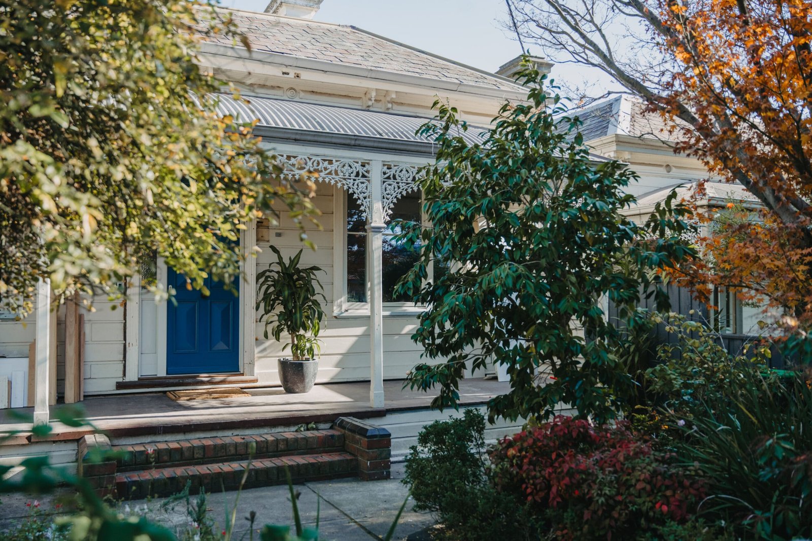 MARIAN HAWTHORN 0067 scaled | Coy's Constructions MARIAN HAWTHORN Restored heritage home with intricate lacework verandah, classic weatherboard facade, and bold blue front door, beautifully renovated by Coy's Constructions in Australia.