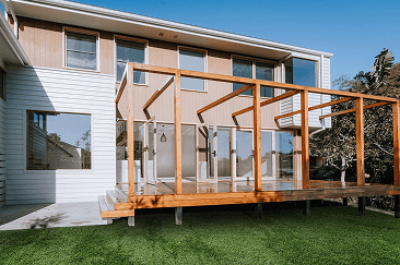Mitcham | Coy's Constructions Mitcham Contemporary two-storey home featuring timber-framed deck, vertical cladding, and large windows, custom built by Coy's Constructions in Australia.