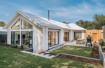 croydon | Coy's Constructions croydon Modern single-storey home with pitched roof, white brick exterior, expansive glazing, and landscaped backyard, expertly designed and built by Coy's Constructions in Australia.